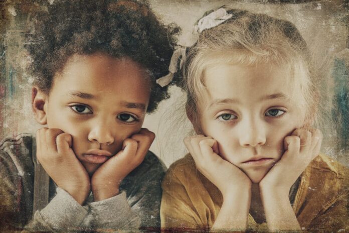 Sad American children sitting together with concern in their eyes, with a faded background suggesting school and community environments