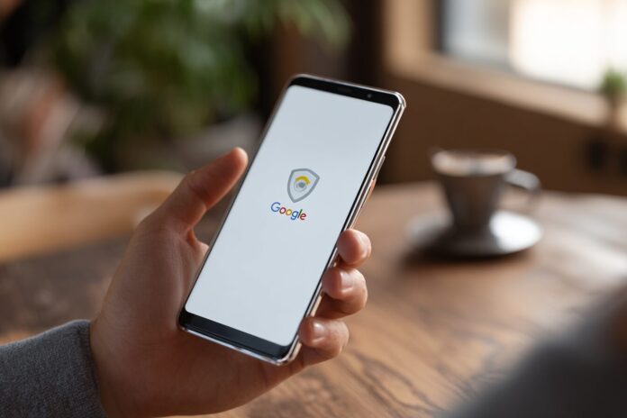 A person holding a smartphone displaying the Google Chrome logo, hinting at secure digital verification.