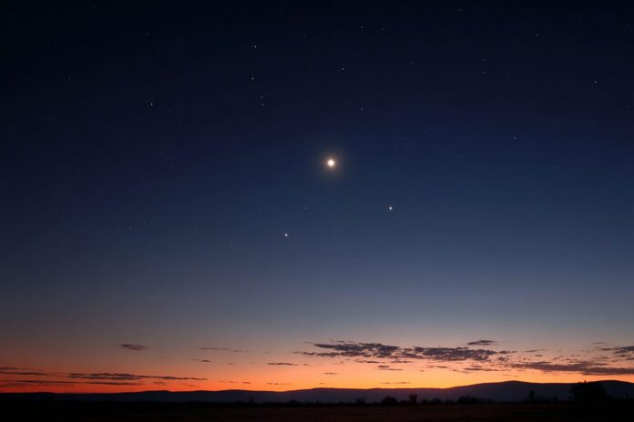 Venus, Jupiter, and Mercury forming a brilliant diagonal before sunrise over a clear, eastern horizon.