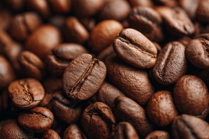 Close-up of light roast coffee beans showing their light brown color and matte surface.