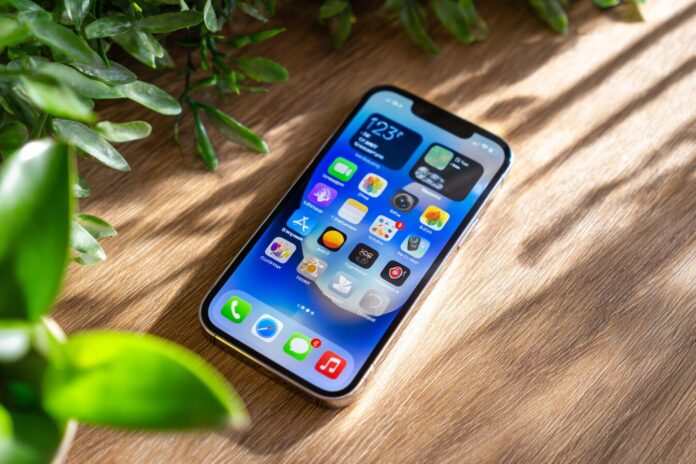 iPhone with iOS 26 Liquid Glass home screen