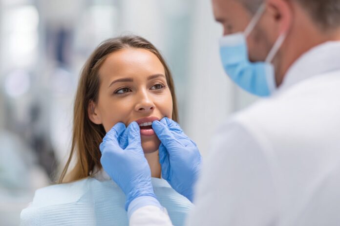 Dental professional examining a patient's gums to highlight oral health importance.